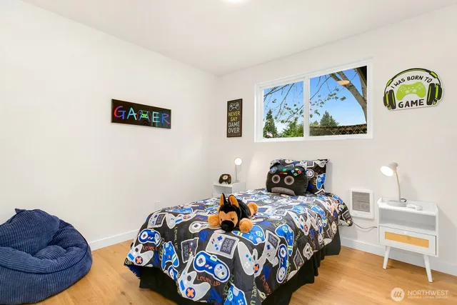 a bedroom with bed and painting on the wall