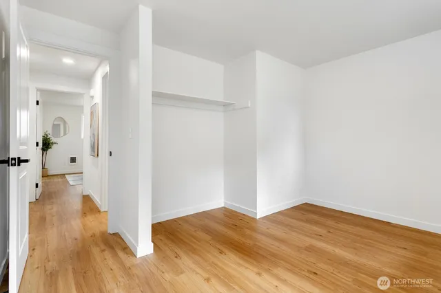 a view of a hallway with wooden floor