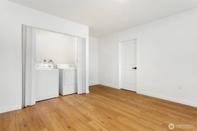 a view of empty room with wooden floor