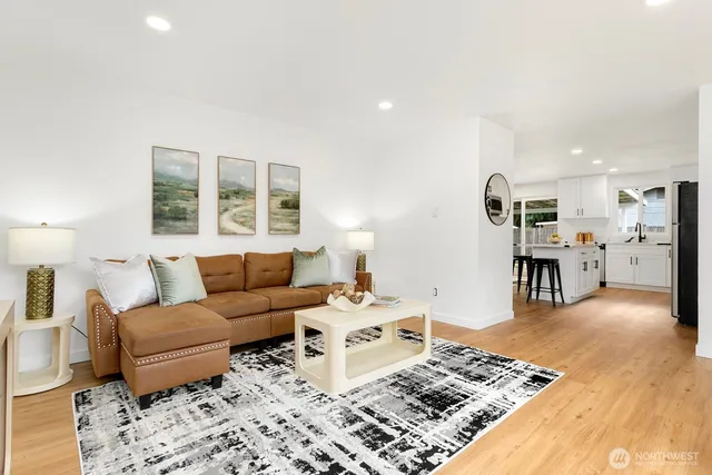 a living room with furniture and wooden floor