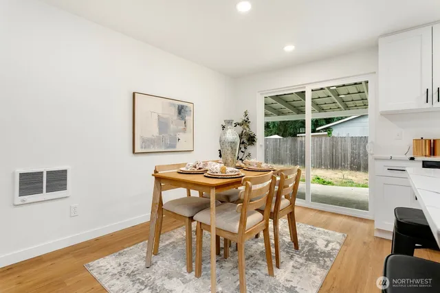 a dining room with furniture and wooden floor