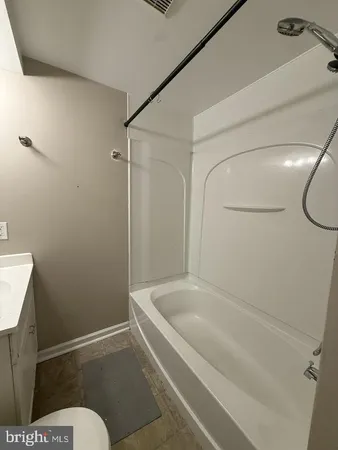 a bathroom with a bathtub and toilet