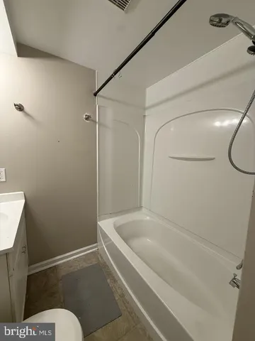 a bathroom with a bathtub and toilet