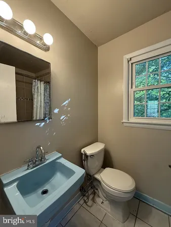 a bathroom with a sink mirror and toilet
