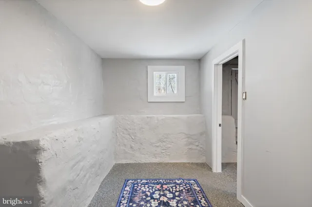 a white toilet sitting next to a white sink
