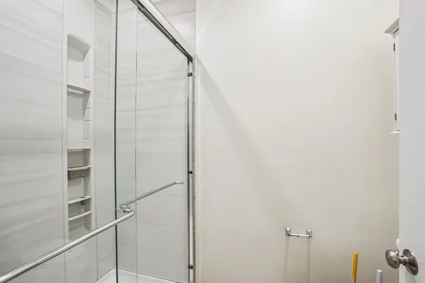 a view of walk in closet with empty racks