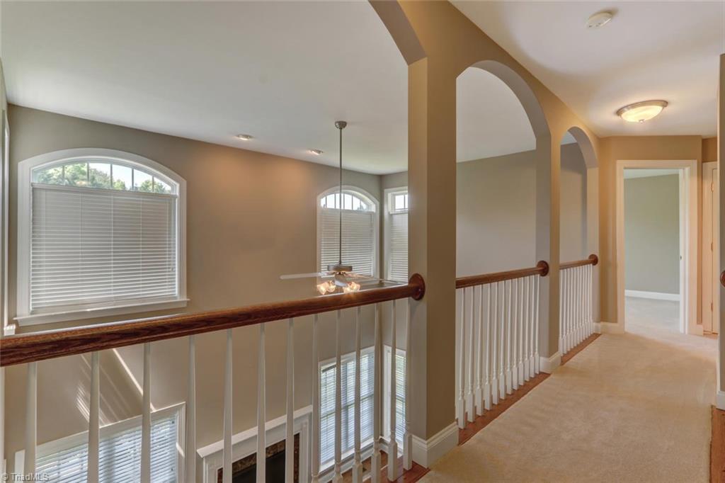 8302 Chartwell Drive Oak Ridge, NC 27310 - Photo 13 of 30 You are welcome to a hallway balcony with three large archways over looking the Great Room once you get to the second floor