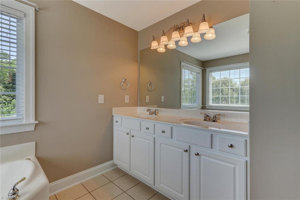 8302 Chartwell Drive Oak Ridge, NC 27310 - Photo 17 of 30 Master Bathroom has double sinks, plenty of counter and cabinet space.