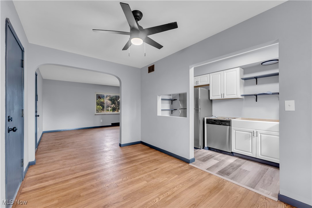 5235 State Road, Unit 3 Cleveland, OH 44134 - Photo 10 of 21 Kitchen with appliances with stainless steel finishes, ceiling fan, white cabinetry, and light wood-type flooring