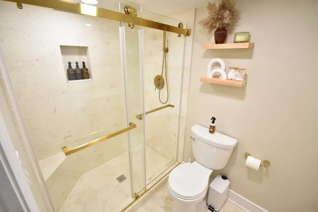 a white toilet sitting next to a bathroom sink