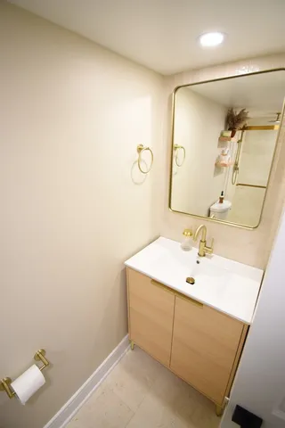 a bathroom with a sink toilet and mirror