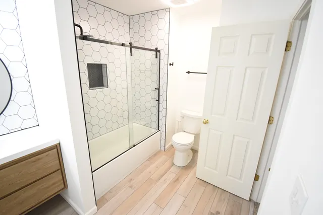 a bathroom with a shower toilet and sink