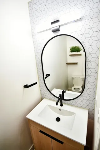 a bathroom with a sink and mirror