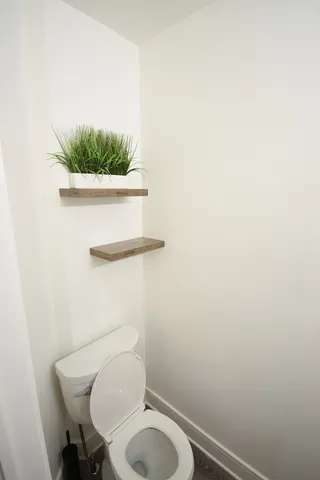 a white toilet sitting next to a small sink