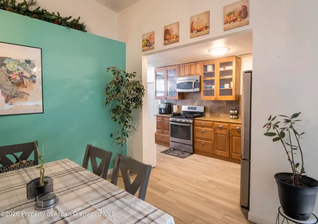 a kitchen with a table and chairs in it