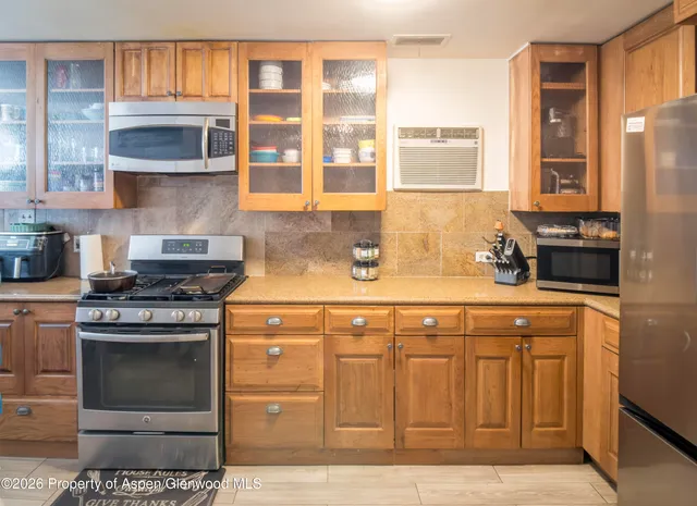 a kitchen with stainless steel appliances granite countertop a stove and a sink