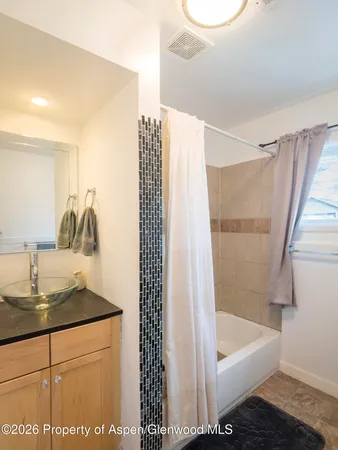 a bathroom with a bathtub and a sink