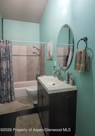 a bathroom with a sink a mirror and a bathtub