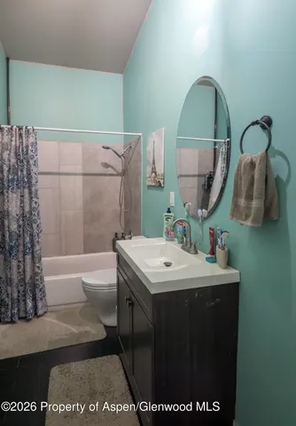 a bathroom with a sink a mirror and a bathtub