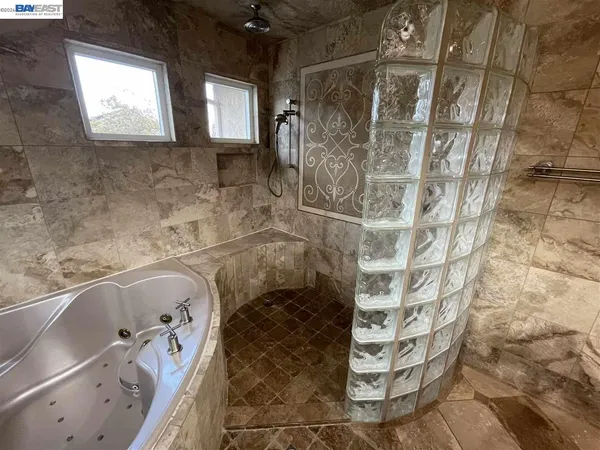 a bathroom with a bathtub and shower