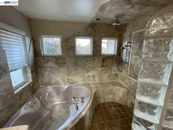 a bathroom with a granite countertop sink a toilet and shower