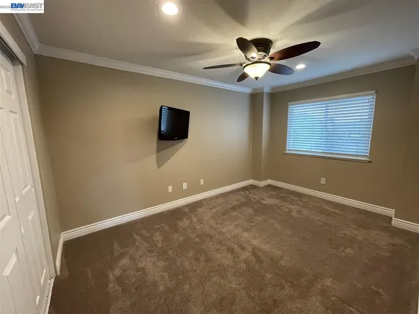 a view of a livingroom with a ceiling fan and a window