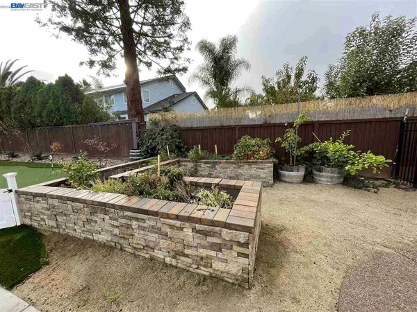 front view of a house with a yard and potted plants