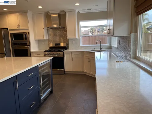 a kitchen with a stove a sink and a refrigerator