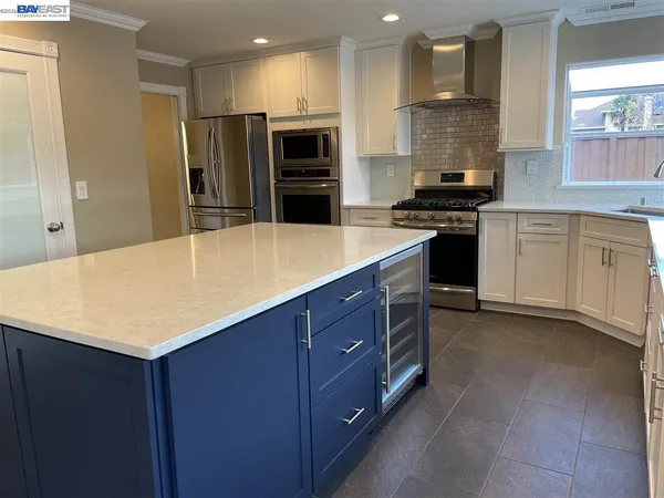 a kitchen with stainless steel appliances a refrigerator and a stove