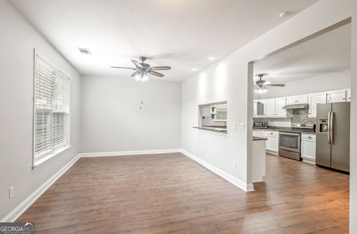 82 Newton Road LaGrange, GA 30240 - Photo 16 of 45 a view of an empty room with kitchen appliances and a ceiling fan
