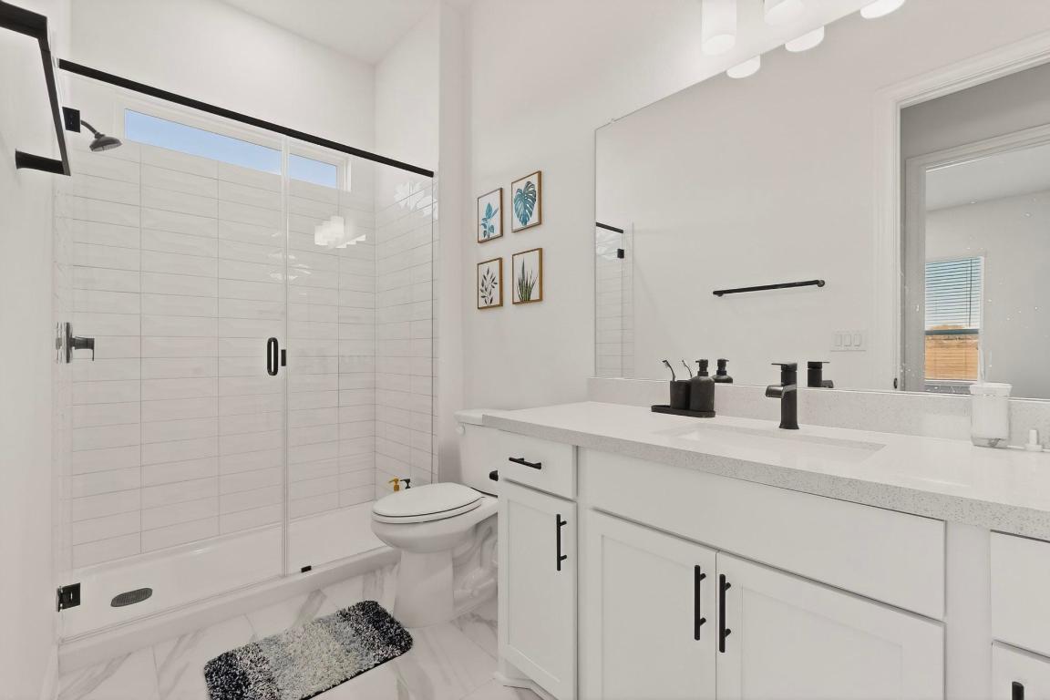 2121 Lolo Lane Leander, TX 78641 - Photo 18 of 26 Bathroom featuring vanity and a shower stall