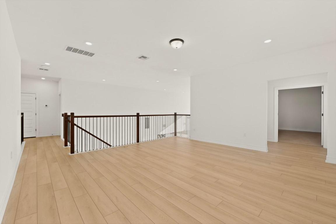 2121 Lolo Lane Leander, TX 78641 - Photo 20 of 26 Empty room featuring light wood-type flooring and recessed lighting