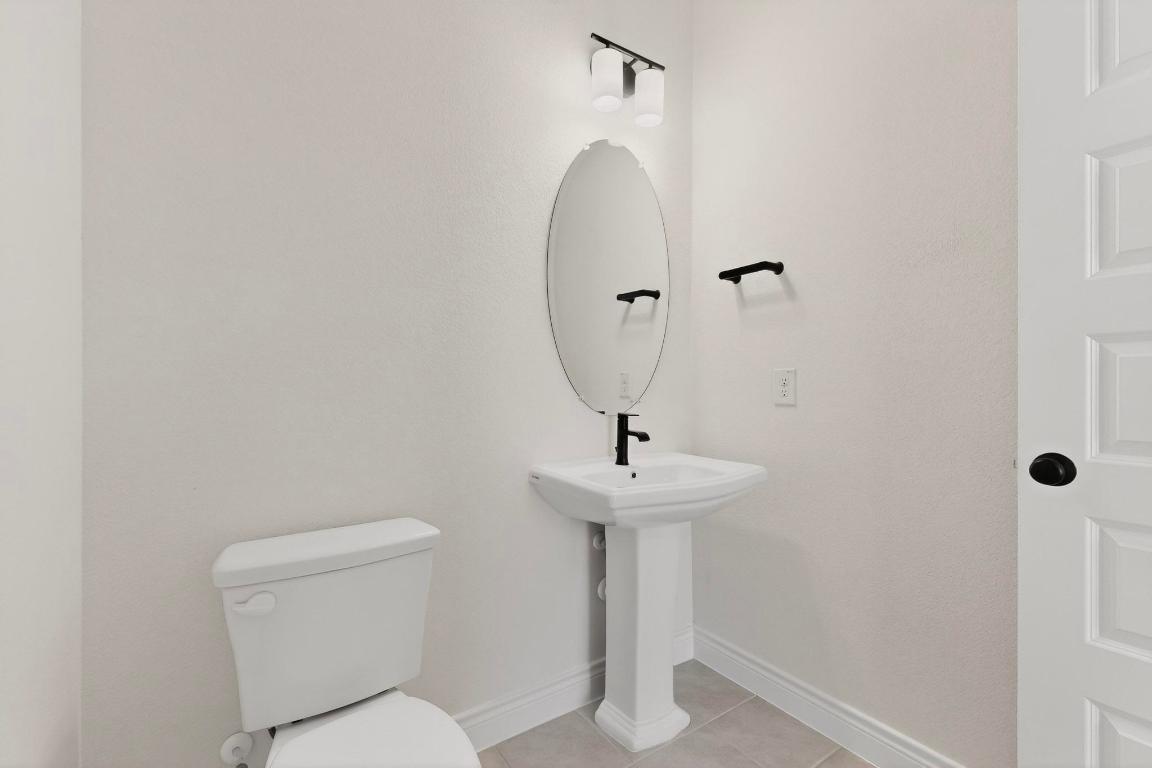 2121 Lolo Lane Leander, TX 78641 - Photo 21 of 26 Bathroom with toilet and light tile patterned floors