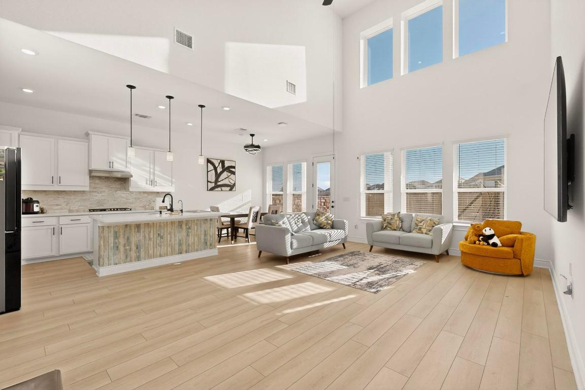 2121 Lolo Lane Leander, TX 78641 - Photo 5 of 26 Living room with light wood-type flooring, ceiling fan, and recessed lighting