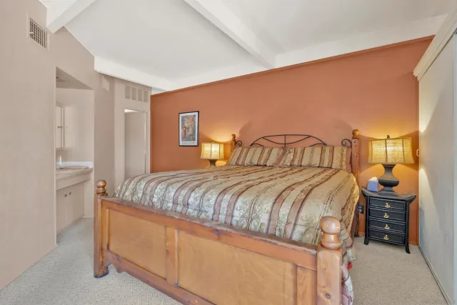 a bedroom with a bed and dresser