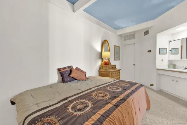 a bedroom with a bed and a dresser