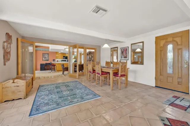 a living room with furniture and a dining table