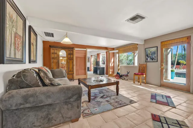 a living room with furniture and large windows