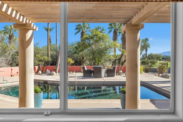 a view of a porch with a floor to ceiling window and wooden floor