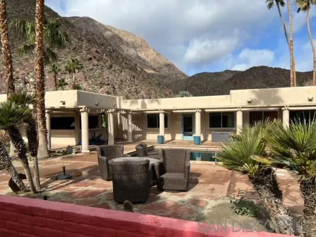 a view of a house with backyard space and sitting area