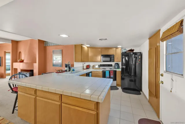a kitchen with a refrigerator and a sink