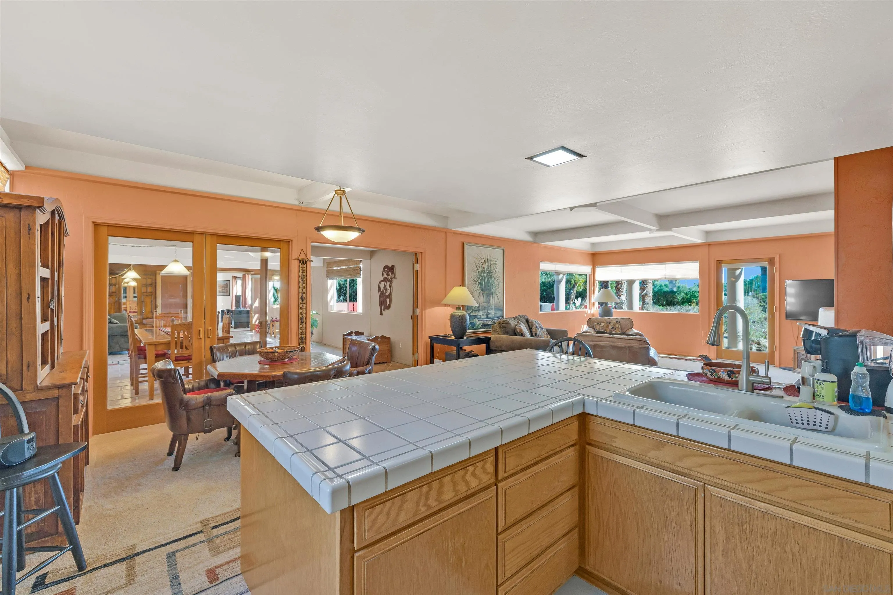 119 Montezuma Road Borrego Springs, CA 92004 - Photo 32 of 47 a kitchen with a stove a sink and living room view