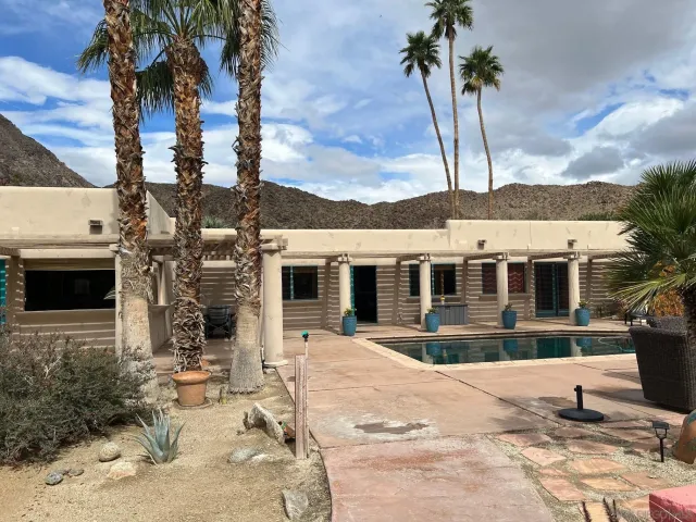 a view of a house with a backyard