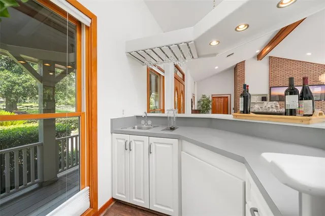 a living room with furniture a flat screen tv and kitchen view