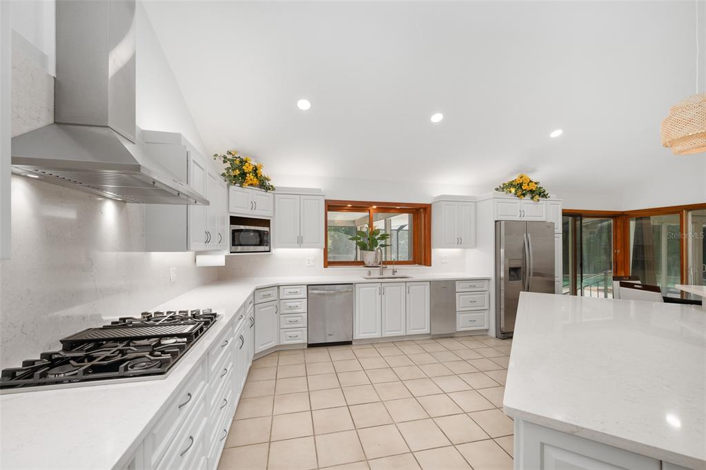413 Southwest 97 Terrace Gainesville, FL 32607 - Photo 17 of 67 a kitchen with a sink a stove and cabinets