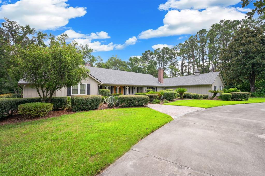 413 Southwest 97 Terrace Gainesville, FL 32607 - Photo 3 of 67 a view of a house with a big yard plants and large trees