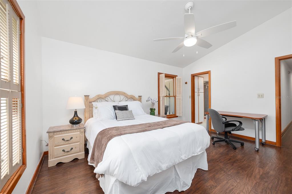 413 Southwest 97 Terrace Gainesville, FL 32607 - Photo 38 of 67 a bedroom with a bed a large window with table and chair