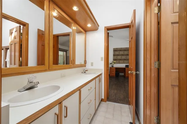 a dining room with furniture wooden floor clock and a chandelier