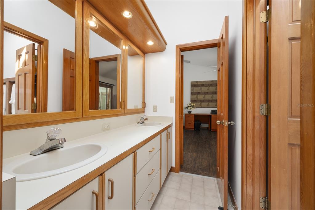 413 Southwest 97 Terrace Gainesville, FL 32607 - Photo 45 of 67 a bathroom with a sink and a mirror