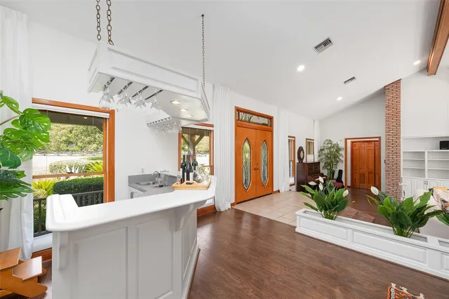 a view of a dining room with furniture wooden floor and a chandelier